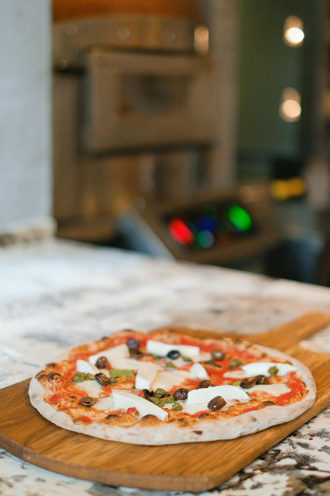 A Mouthwatering Artisan Pizza With Cheese Olives